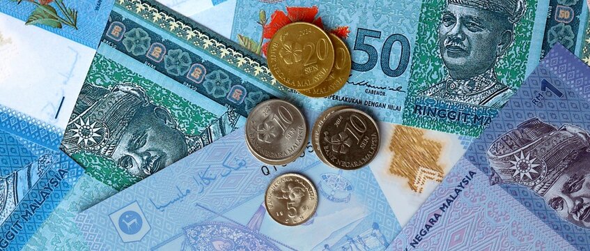 Malaysian ringgit money notes and coins on table. Malaysia cash bills of MYR currency close up
