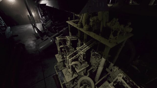 Rusty machinery looms in the shadows of an abandoned industrial site, showcasing times effect on metal. Soft light filters through, revealing the complex network of pipes and gears.