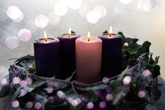 Traditional Christian Christmas Advent wreath with three purple and one rose candle.