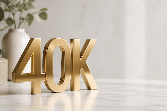 Gold-colored letters spelling "40K" are displayed on a white marble surface with a potted plant in the background.