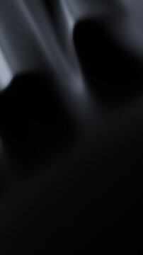 Abstract reflective ripples on black surface. Dark water waves. Glossy satin-like folds. Loop 3D render animation. Vertical Video.