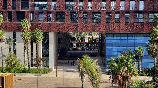 skyscraper building view in Casa Finance City buildings CFC from Anfa Park on a sunny day, Casablanca tramway passing through the building