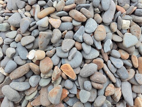 Natural smooth river rocks and pebbles background texture photo