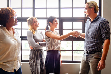 Diverse team greeting each other in bright office © Rawpixel.com