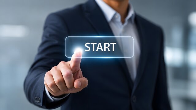 A businessman in a formal suit presses a glowing digital start button, symbolizing the initiation of a new business venture or a technological process launch.
