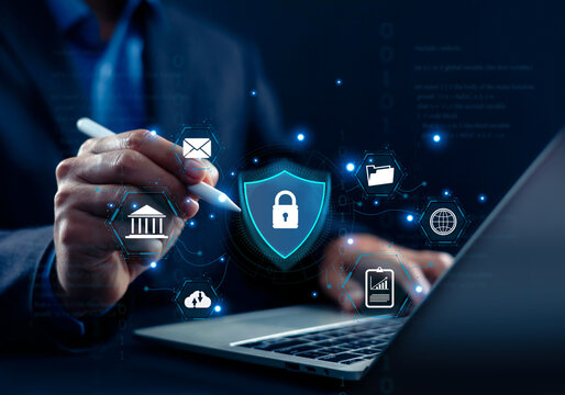 Business person using a laptop with a glowing cybersecurity shield lock icon and digital service interfaces. Concept of data protection, network security, banking, and online privacy.