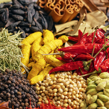 colorful heaps of whole spices and seasoning powders, fragrant flavoring as a background