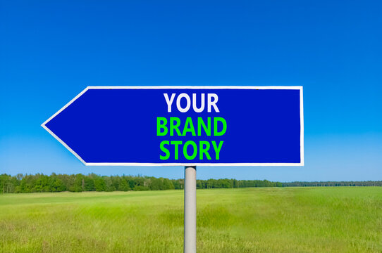 Branding and your brand story symbol. Concept words Your brand story on beautiful blue road sign. Beautiful blue sky green grass background. Business branding your brand story concept. Copy space.