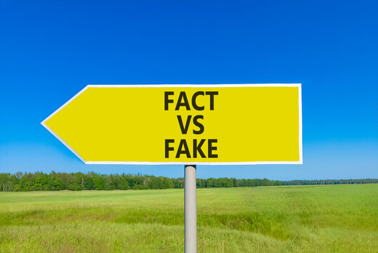 Fact vs versus fake words symbol. Concept words Fact vs Fake on beautiful yellow road sign. Beautiful blue sky green grass background. Business and fact vs versus fake concept. Copy space.