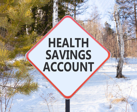 Health saving account symbol. Concept words Health saving account on beautiful white road sign. Beautiful winter forest background. Medical Health saving account concept. Copy space.