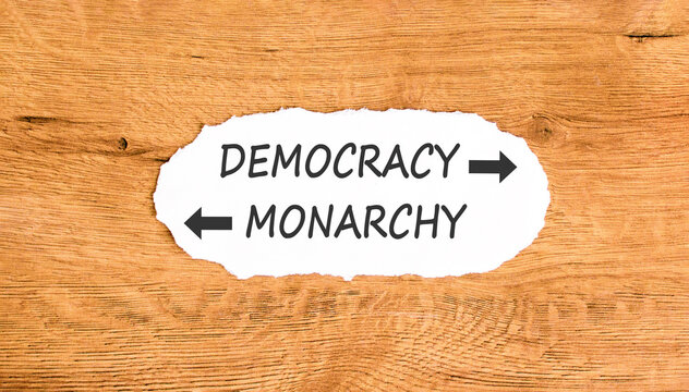 Democracy or monarchy words symbol. Concept words Democracy Monarchy on beautiful white paper. Beautiful wooden background. Business democracy monarchy concept. Copy space
