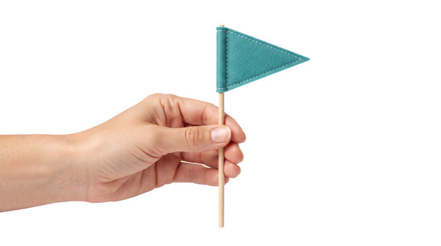 Hand holding a small teal green triangular flag on a wooden stick isolated on a white background