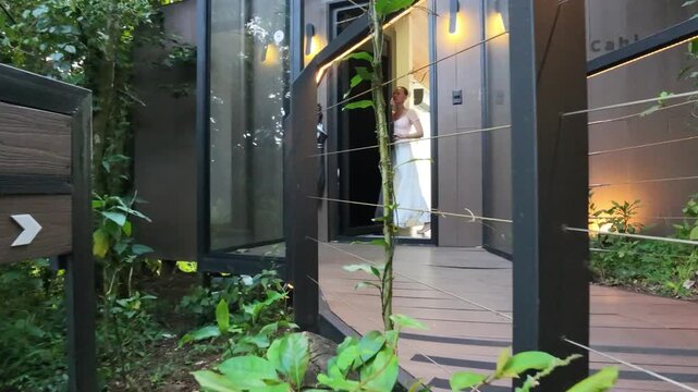 FPV Drone Flight along a Forest Boardwalk past the Amalu Glass Cabin Sign through the Door and Inside to the Glass Floor with Valley View, Monteverde, Costa Rica