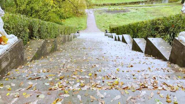POV walkthrough of an empty stone staircase, shot on stabilizer in Pavlovsk Park, Russia, slow motion. Smooth forward camera motion evokes a serene, quiet, and nostalgic autumn mood.