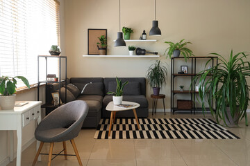 Modern home interior with biophilic design, cozy living room with grey sofa, indoor plants and minimalist furniture for comfortable lifestyle living © Pixel-Shot