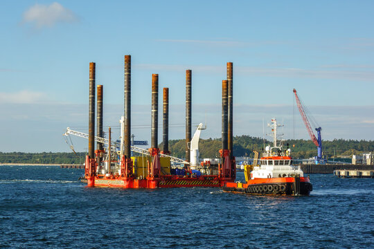 Tugboat Towing Offshore Jack-Up Construction Barge Platform. Offshore Construction, Marine Industry and Energy Infrastructure