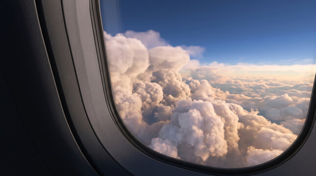 View from an airplane window overlooking fluffy clouds against a blue sky, symbolizing journey, freedom, and perspective