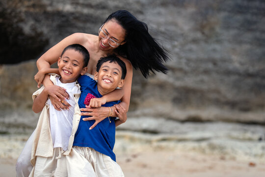 Asian family enjoying outdoor recreation and quality time together on the coast