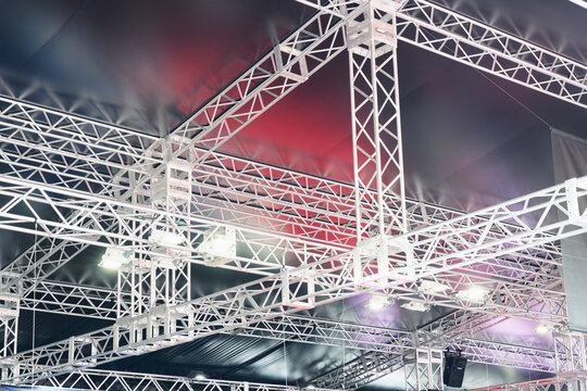 Metal Truss Framework and Lights Beneath a Dark Canopy
