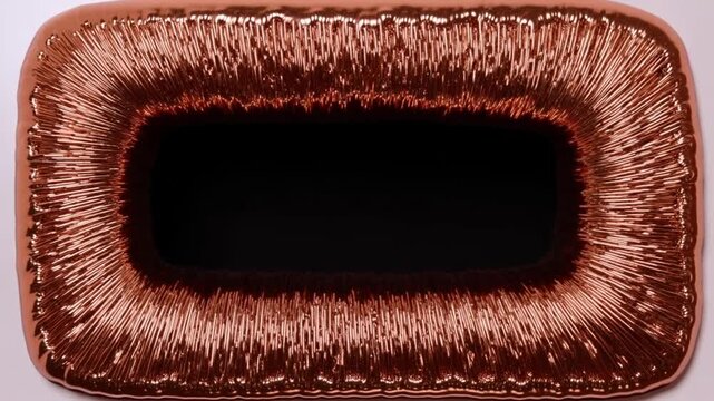 Copper ferrofluid spikes forming rectangular frame around dark center on white surface