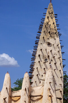 Minaret of the Grand Mosque with wooden beams and loudspeakers against a blue sky, Hauts-Bassins Region, Bobo Dioulasso, Burkina Faso