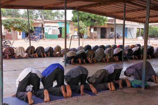Muslim men bowing in prostration during prayer at the Grand Mosque, Hauts-Bassins Region, Bobo Dioulasso, Burkina Faso