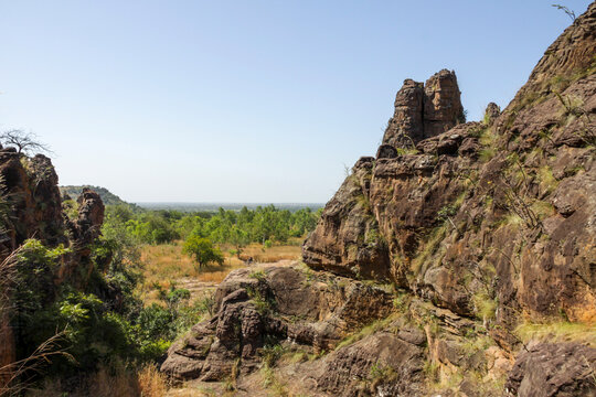 Rocky outcrop of the Sindou Peaks overlooking a green valley, Cascades Region, Banfora, Burkina Faso