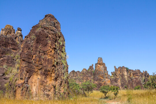 Tall sandstone needle and rock towers of the Sindou Peaks in golden grass, Cascades Region, Banfora, Burkina Faso