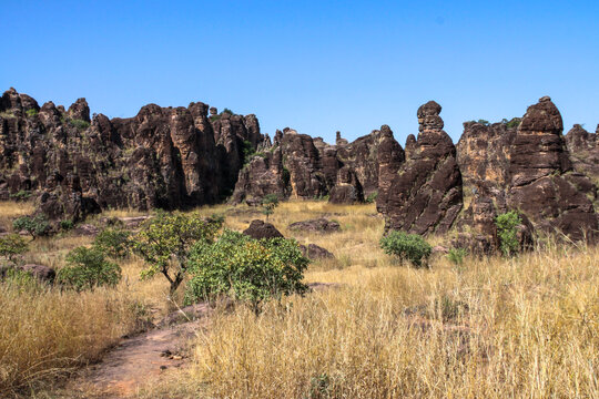 Chain of rock towers of the Sindou Peaks above dry savanna grass, Cascades Region, Banfora, Burkina Faso