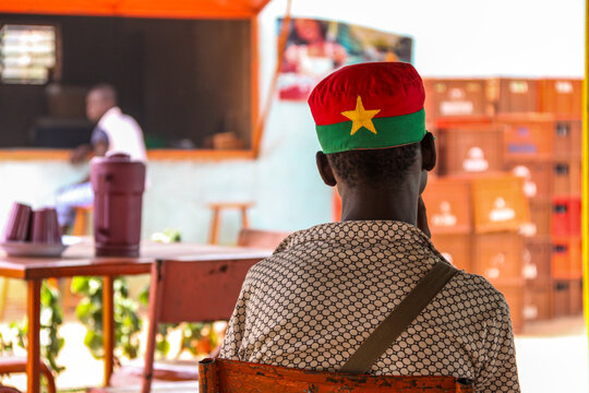 Man of the Lobi tribe seen from behind wearing a cap in the national flag colors, Sud-Ouest Region, Gaoua, Burkina Faso