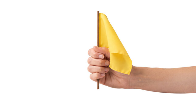 Hand holding small yellow flag isolated on a white background, representing signal or attention concept