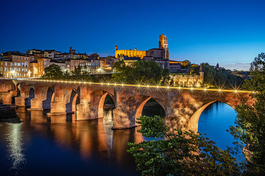 Albi, France - Albi featuring the Sainte-C&eacute;cile cathedral and the Pont Vieux (old bridge) over the river Tarn in the Occitanie region of France at Blue Hour.