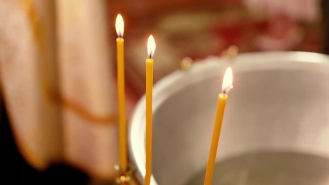Orthodox Christian baptism of a baby in a church, featuring sacred icons, crosses, candles, and religious rituals symbolizing faith, spiritual blessings, and family traditions.