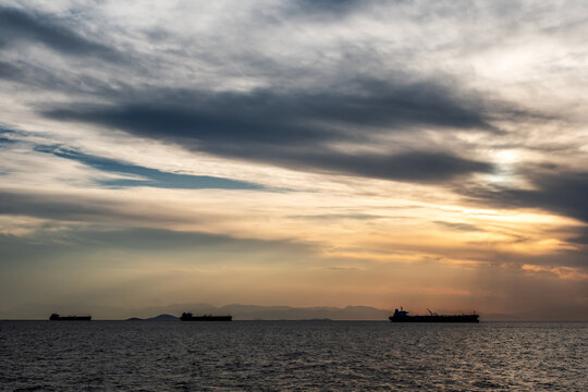 Crude oil tankers in the sea at sunset. Oil and gas industry. Tankers crude oil carrier ship designed for transporting grude oil