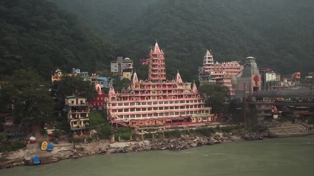 Drone view of Tera Manzil Temple or Trimbakeshwar Temple located on the banks of the Ganges River near Laxman Jhula in Rishikesh, Uttarakhand, India. 