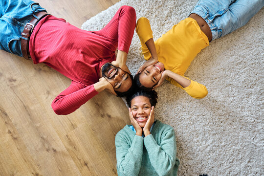 Portrait of mother, father and daughter having fun at home, family life, parenting, love and bonding concepts