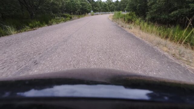 Driving Along Curving Rural Asphalt Road Through Dry Scrubland