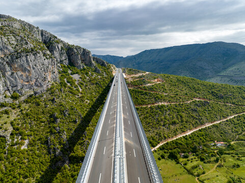 Highway Runs Through Rocky Mountains in Rural Landscape