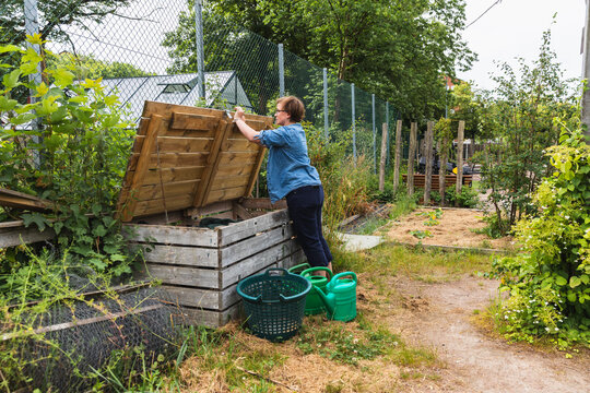 Woman Opening Large Wooden Garden Storage and Compost Box