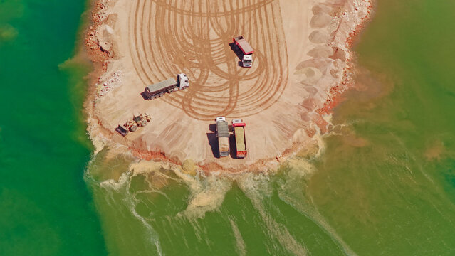 Sand mining with trucks and heavy machinery