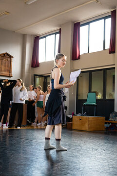 Performer glancing over her script