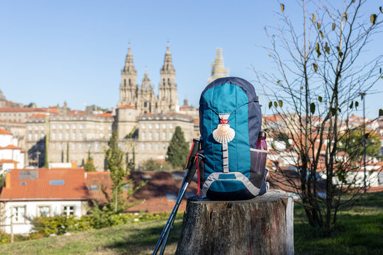 pilgrim backpack and poles with santiago de compostela cathedral in background