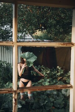 Portrait Woman with Large Leaf in Garden