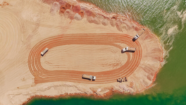 Aerial view showing earthmoving trucks working at quarry site