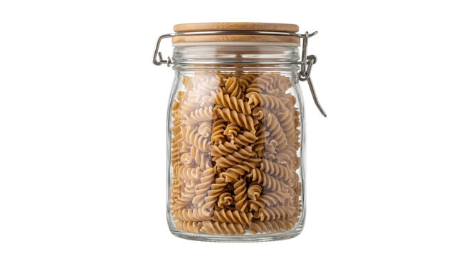Whole wheat fusilli pasta stored in a clear glass jar with a wooden lid on white background