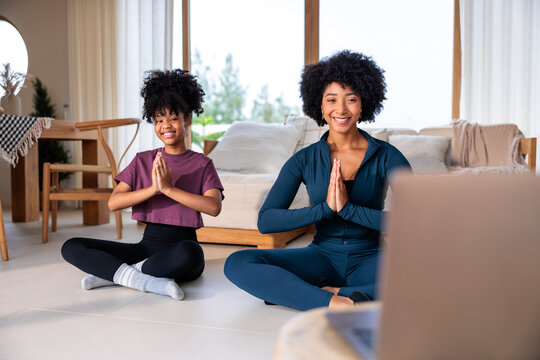 Mom and daughter meditate together