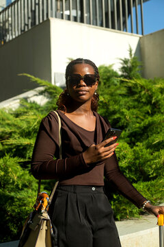 Black woman professional with suitcases in business trip.