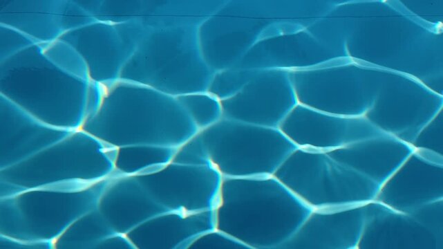 Pool water blue caustics swimming ripples surface sunlight refraction clear aqua waves liquid texture clean resort summer underwater transparent