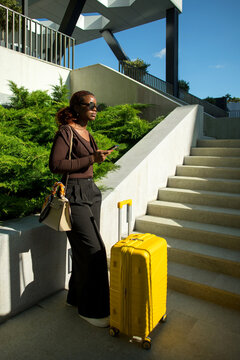 Black woman professional with suitcases in business trip.