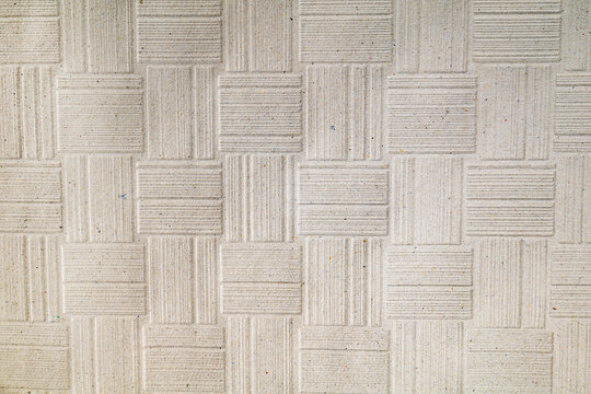 textured fabric surface with alternating square tile pattern and parallel line orientation